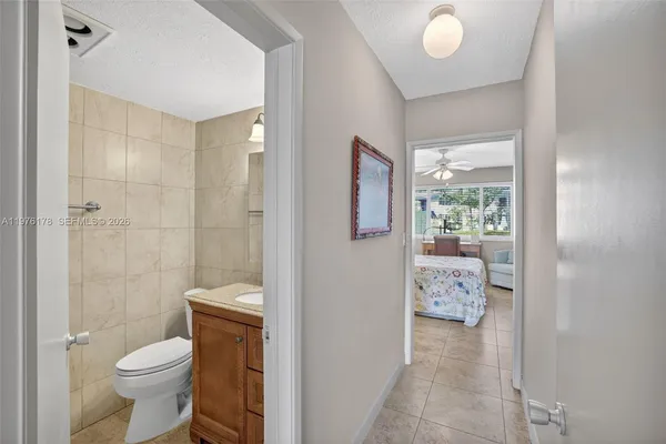 a bedroom with a bed and a large mirror with dresser