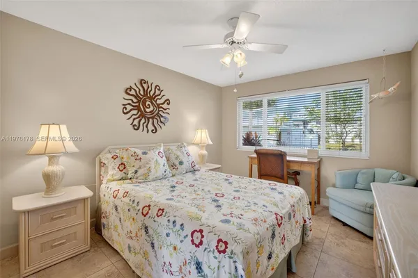 a bathroom with a granite countertop sink a toilet and a mirror