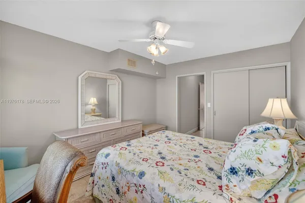 a living room with furniture large windows and flat screen tv