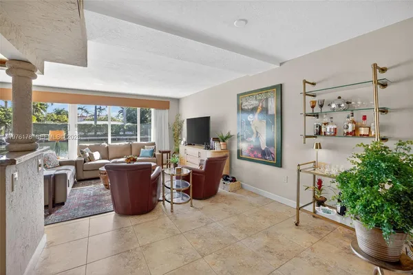 a bedroom with furniture and a large window