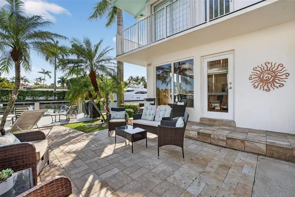 a view of a swimming pool with a patio and a yard