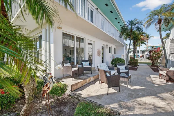 a view of a swimming pool with a patio and a fountain