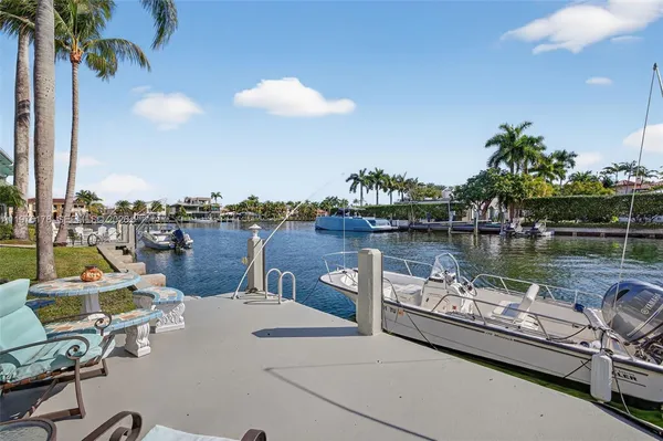 a view of a house with a yard and potted plants