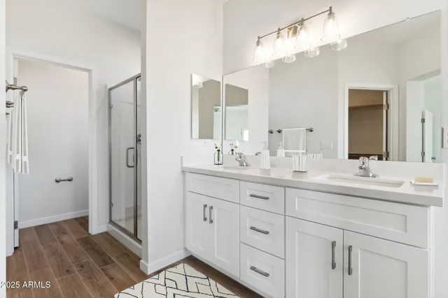 a bathroom with double sink and a mirror