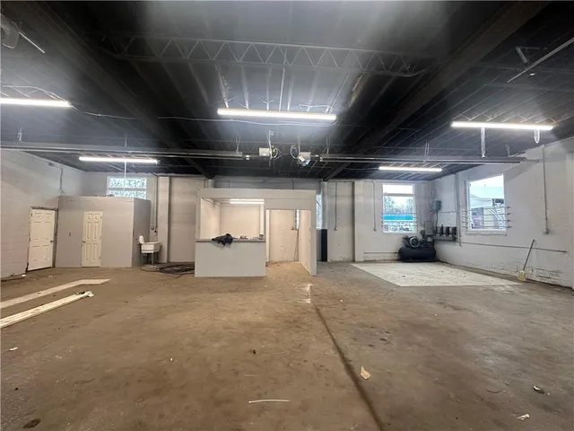 a view of an empty room with a fireplace