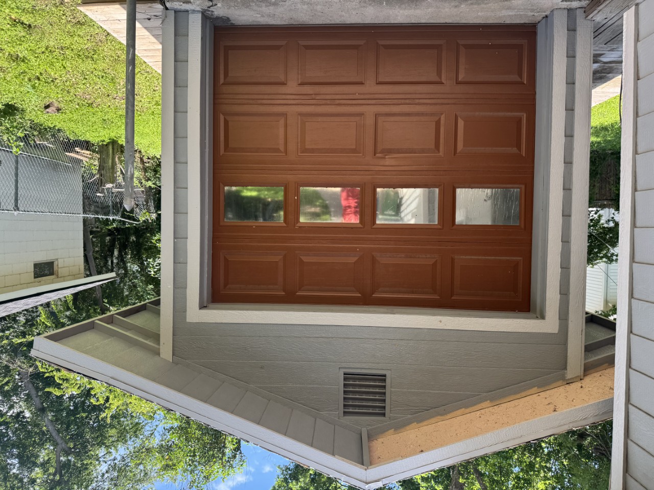 1813 Rhodes Road Austin, TX 78721 - Photo 14 of 14 A detached garage offers convenient vehicle storage with an eye-catching wood-paneled door.