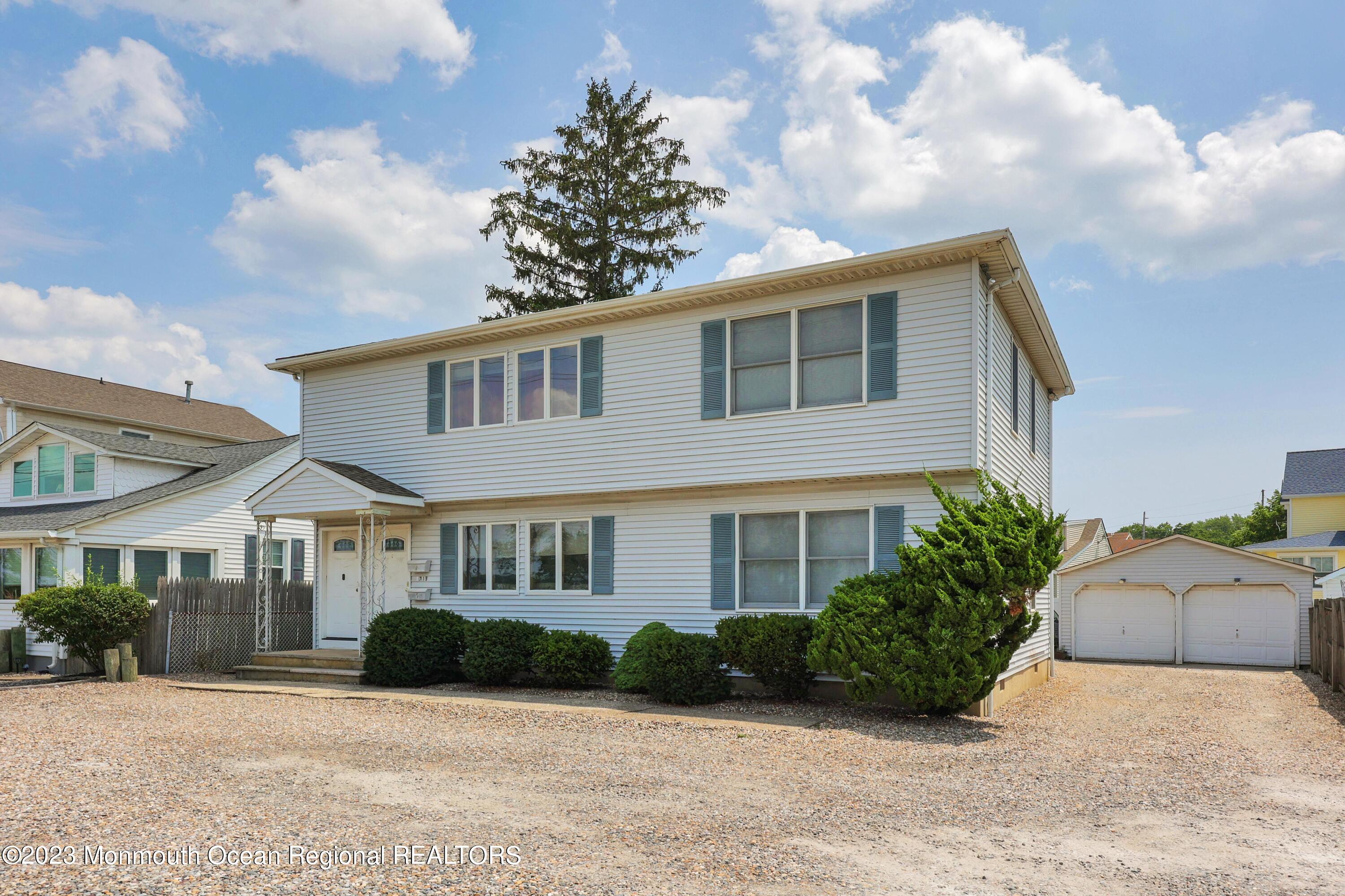 1719 River Road Belmar, NJ 07719 - Photo 1 of 32 a front view of a house with a garden
