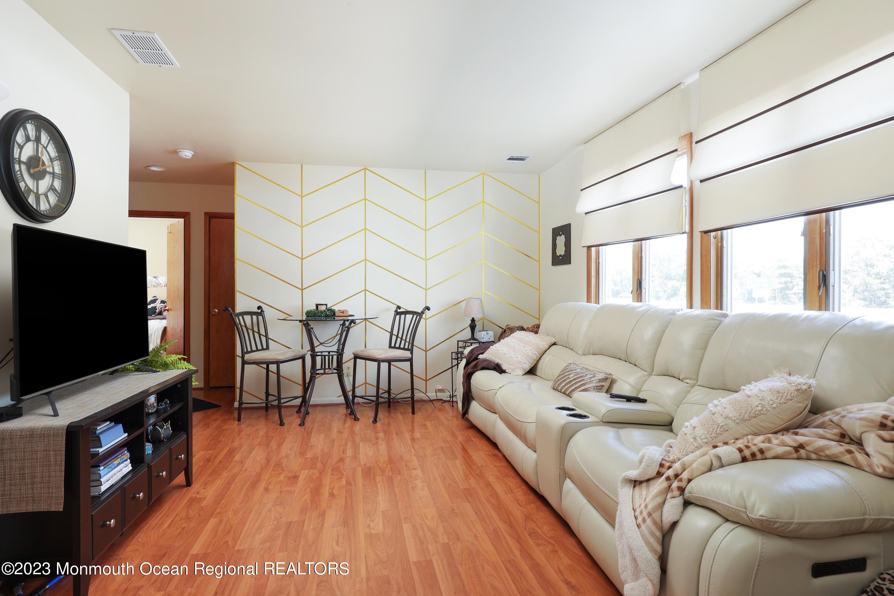 1719 River Road Belmar, NJ 07719 - Photo 11 of 32 a living room with furniture and a flat screen tv