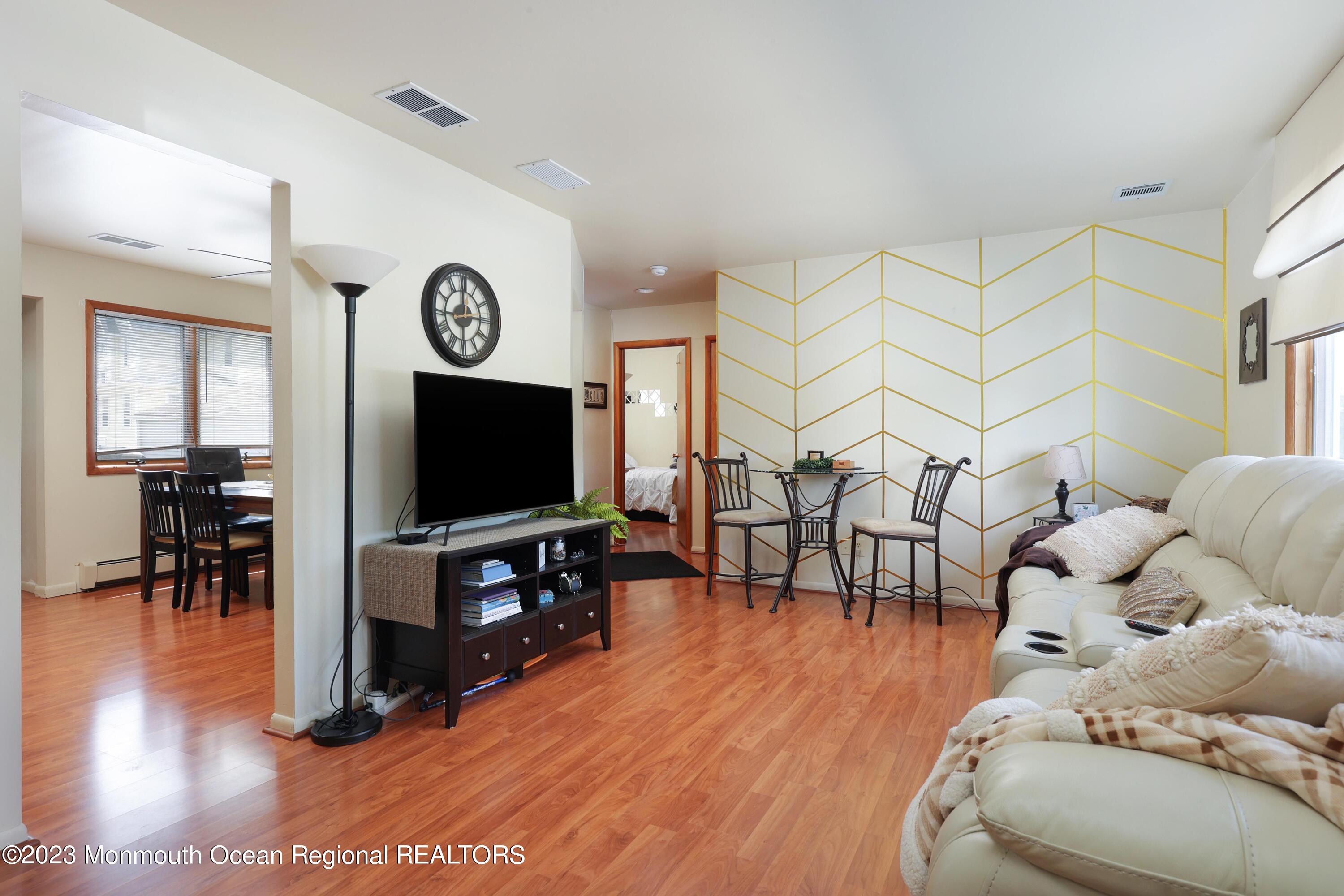 1719 River Road Belmar, NJ 07719 - Photo 12 of 32 a living room with furniture and a flat screen tv