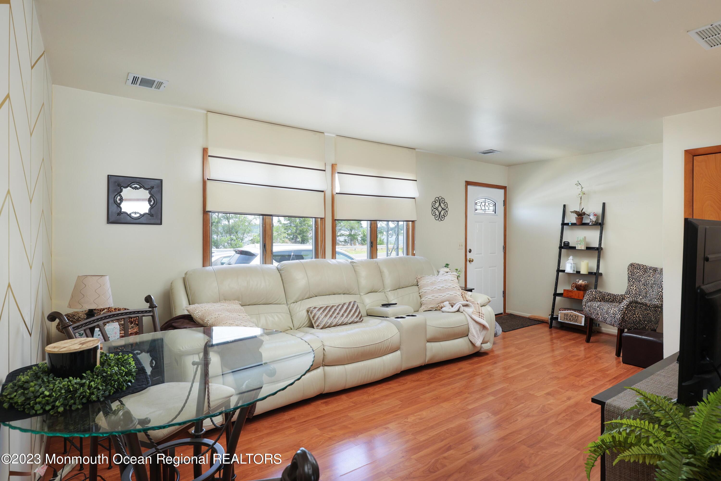 1719 River Road Belmar, NJ 07719 - Photo 13 of 32 a living room with furniture and a large window