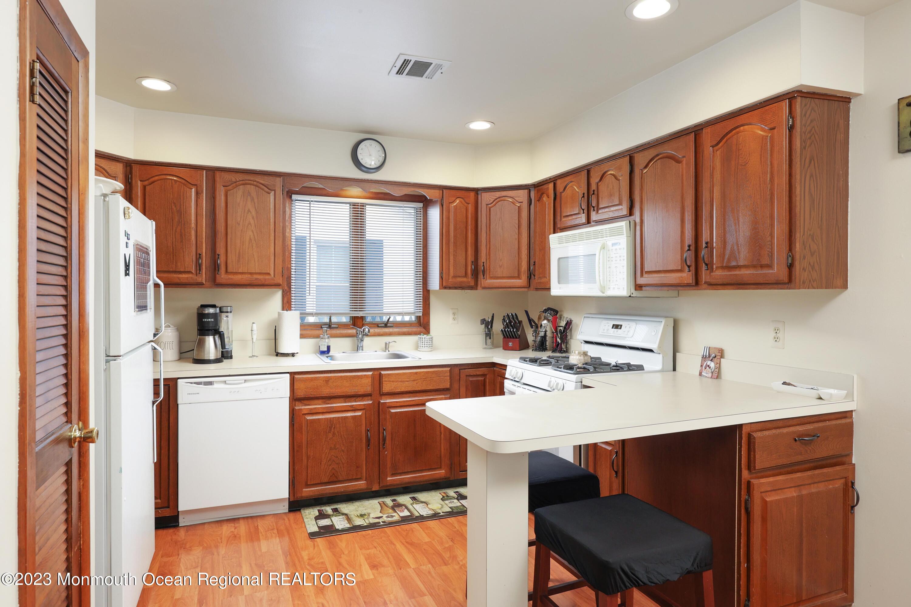 1719 River Road Belmar, NJ 07719 - Photo 16 of 32 a kitchen with a sink cabinets and window