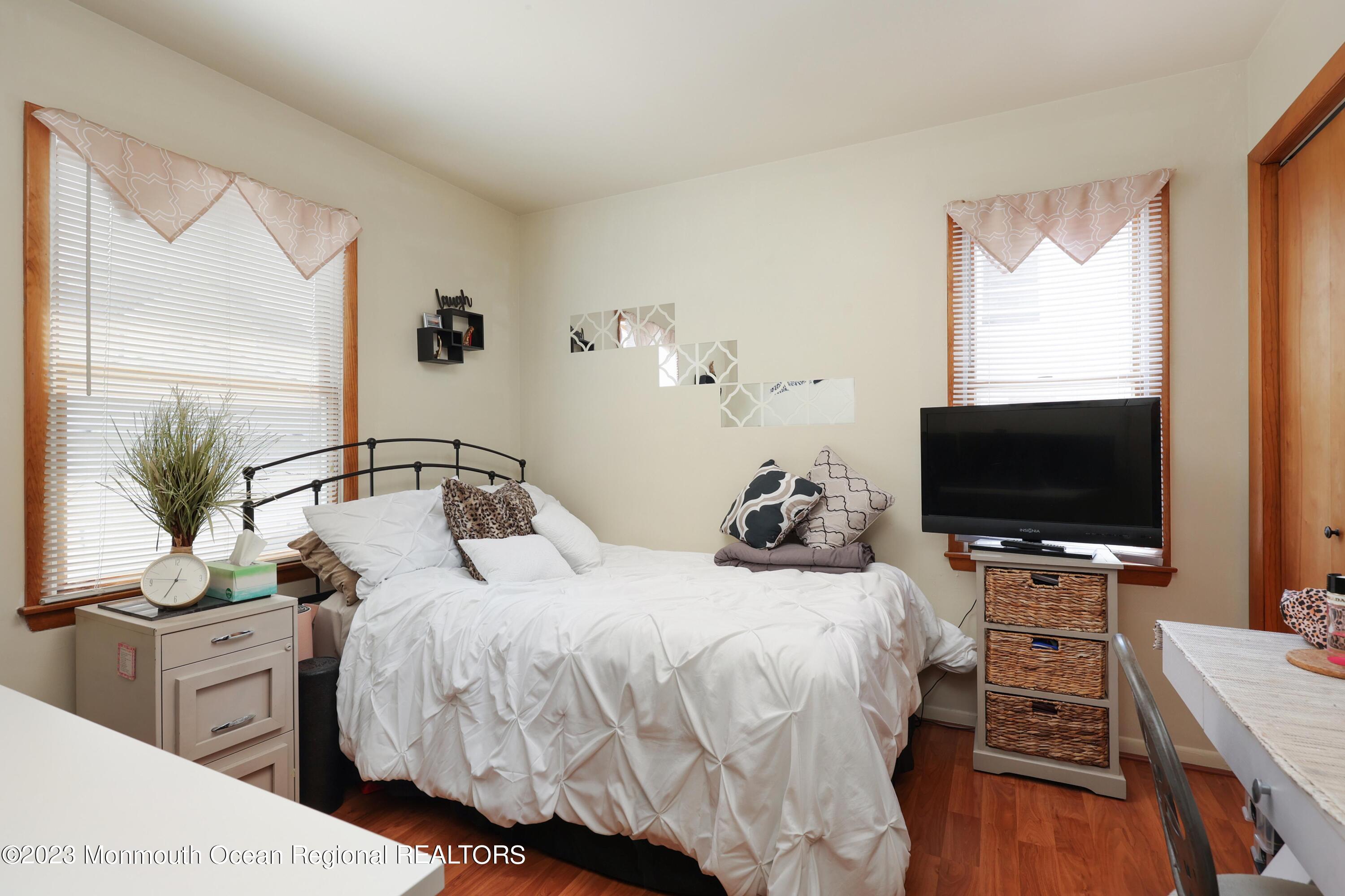 1719 River Road Belmar, NJ 07719 - Photo 19 of 32 a bedroom with a bed and a flat screen tv
