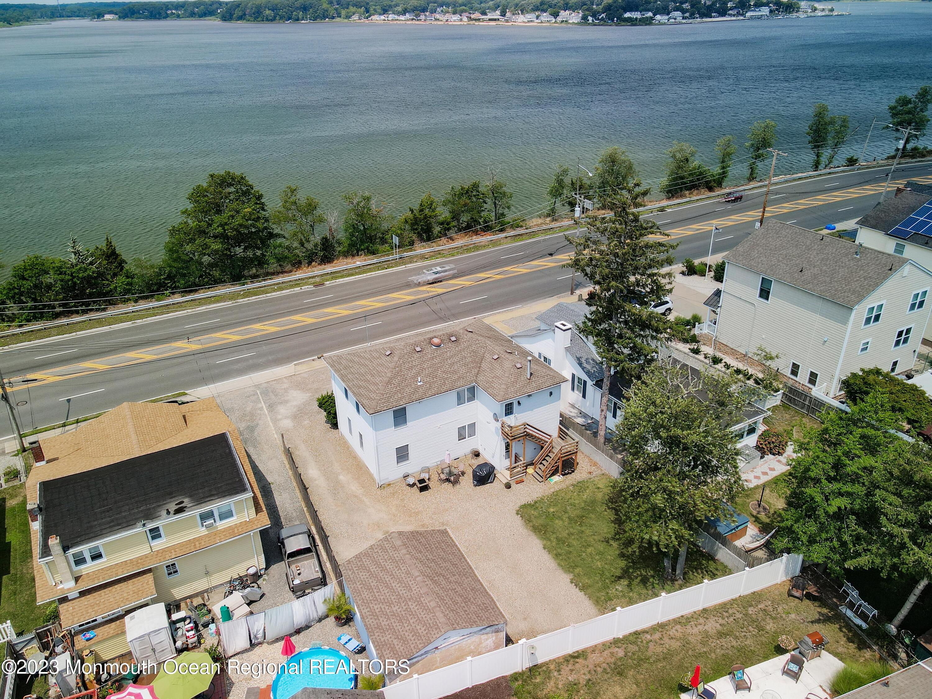 1719 River Road Belmar, NJ 07719 - Photo 22 of 32 an aerial view of a house with a yard wooden table and chairs