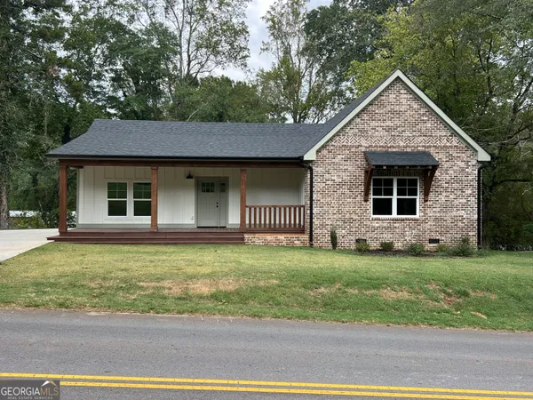 a front view of a house with a garden
