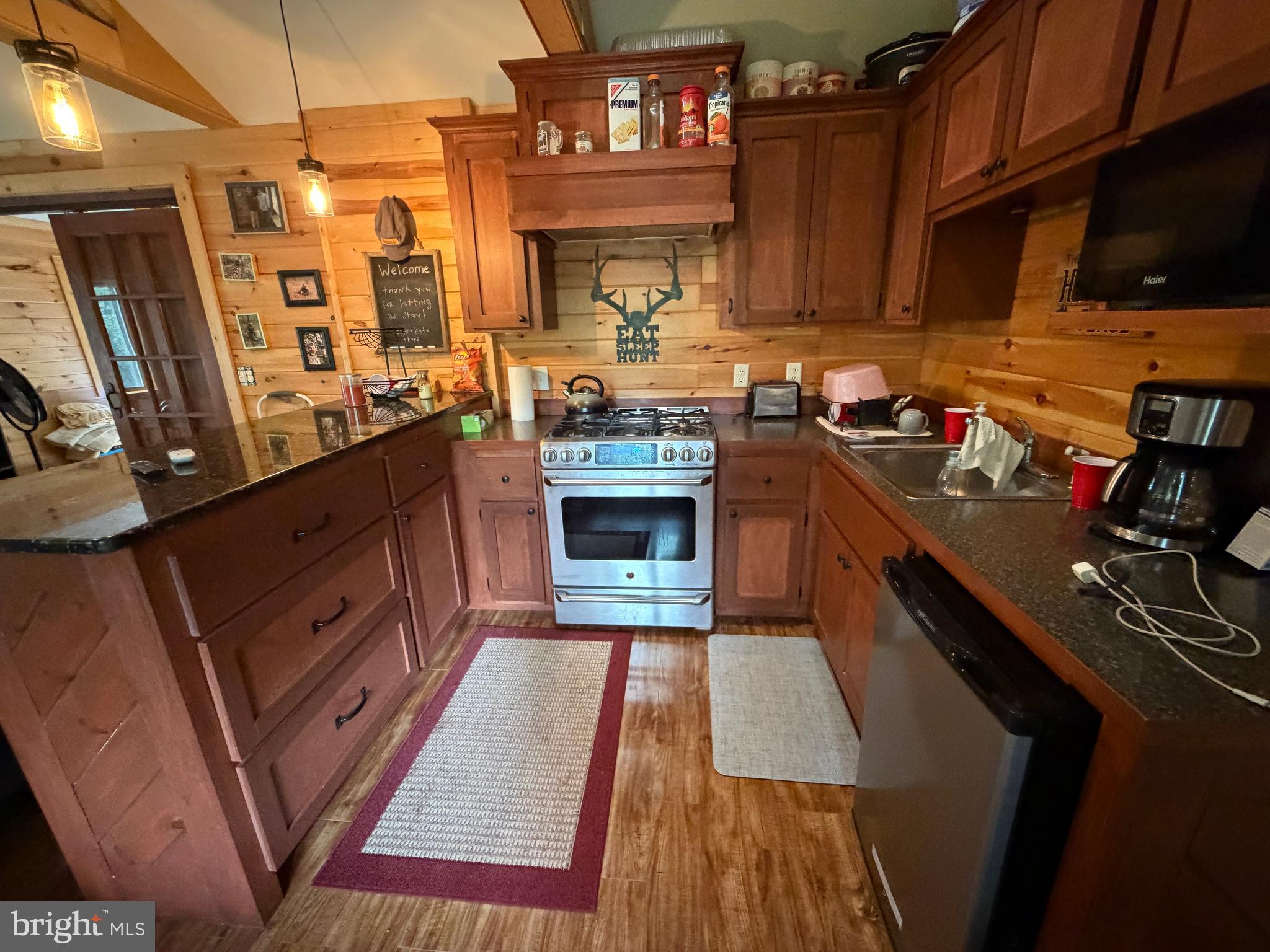 1419 Paul's Woods Road Delray, WV 26714 - Photo 22 of 105 a kitchen with stainless steel appliances granite countertop a stove a sink dishwasher and a microwave oven with cabinets