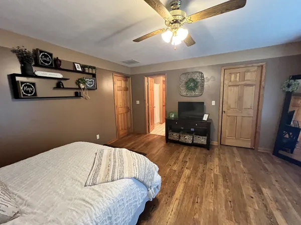 a bedroom with a bed and a chandelier