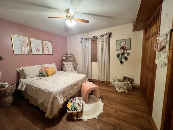 a bedroom with a bed and a chandelier