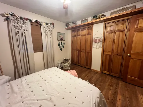 a bedroom with a large bed and wooden door