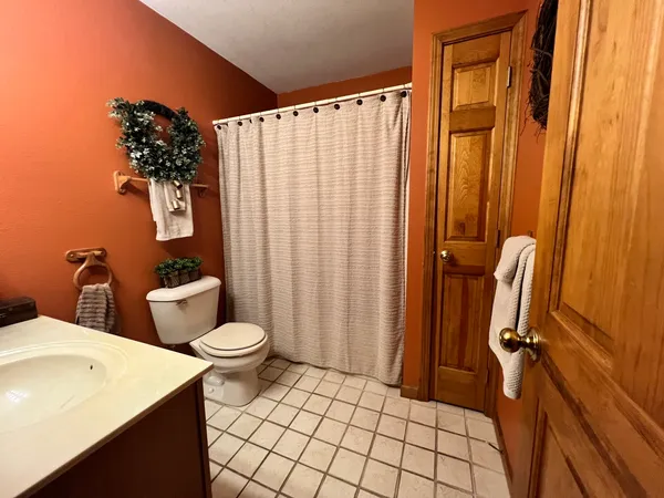 a bathroom with a toilet and shower