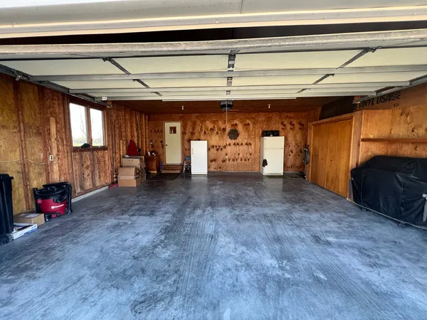 a view of empty room with wooden floor and windows