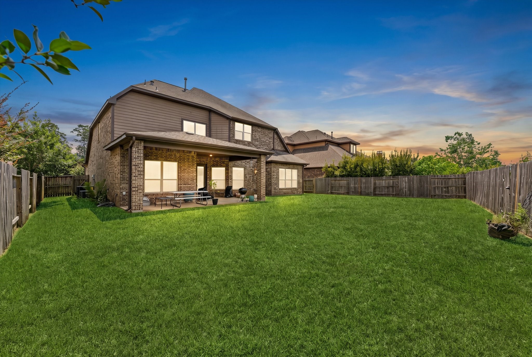 2506 Barclay Lake Lane Spring, TX 77388 - Photo 26 of 35 As the sun sets, this spacious backyard becomes the perfect peaceful escape with lush green space, a covered patio, and plenty of room to relax under the evening sky.
