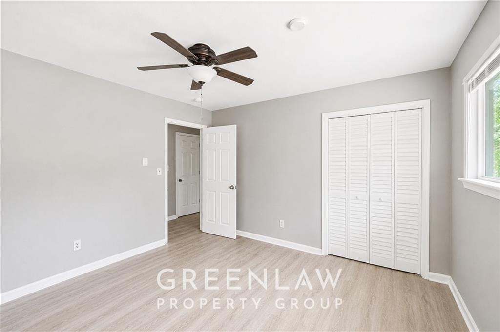 3605 Flat Shoals Road Atlanta, GA 30349 - Photo 13 of 35 a view of a livingroom with a ceiling fan and wooden floor