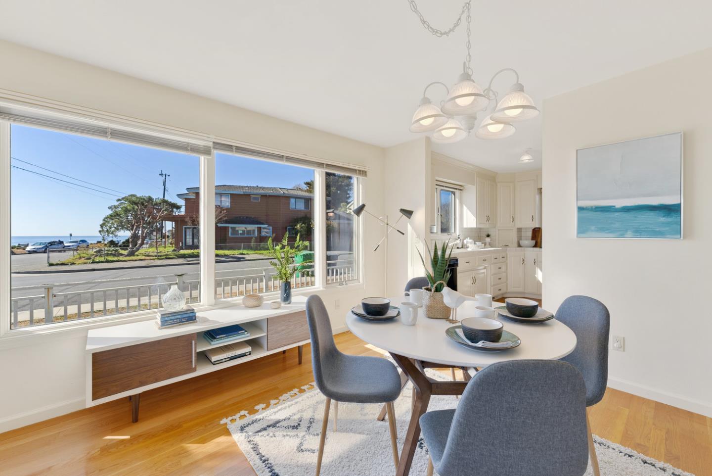 1385 Prospect Avenue Capitola, CA 95010 - Photo 16 of 41 a view of a dining room with furniture wooden floor and a chandelier