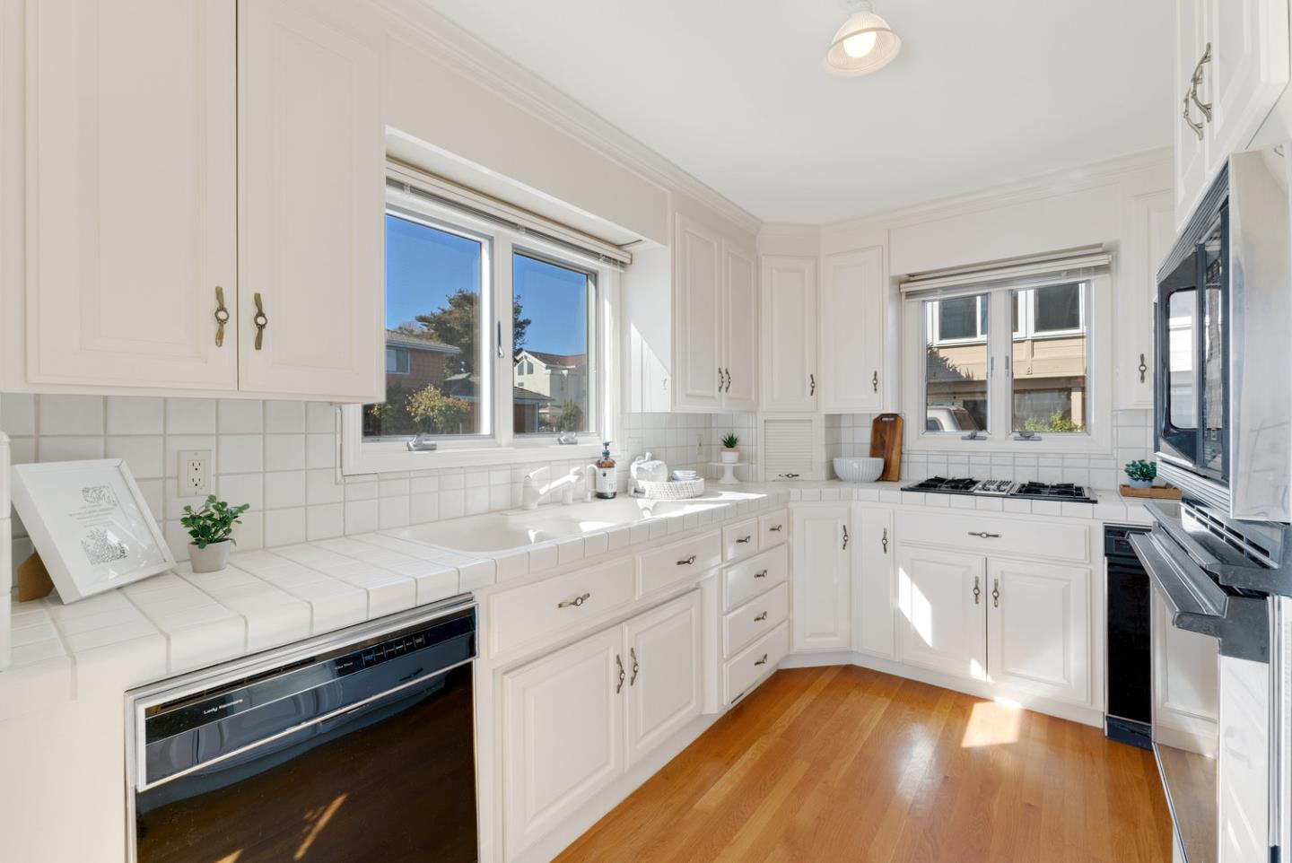 1385 Prospect Avenue Capitola, CA 95010 - Photo 19 of 41 a kitchen with a sink stove and cabinets