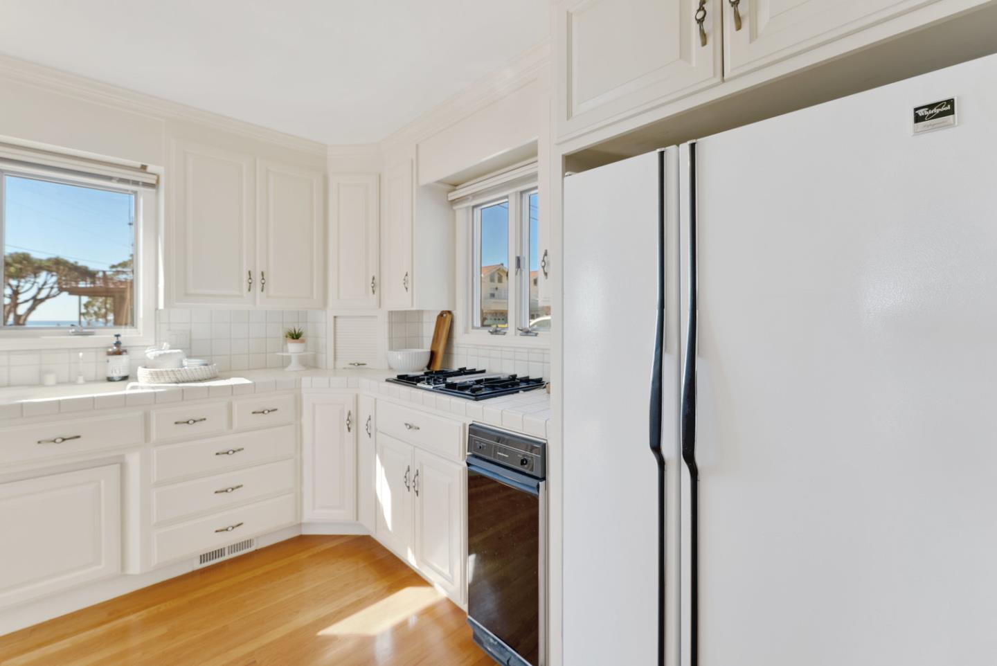 1385 Prospect Avenue Capitola, CA 95010 - Photo 20 of 41 a kitchen with white cabinets and white appliances