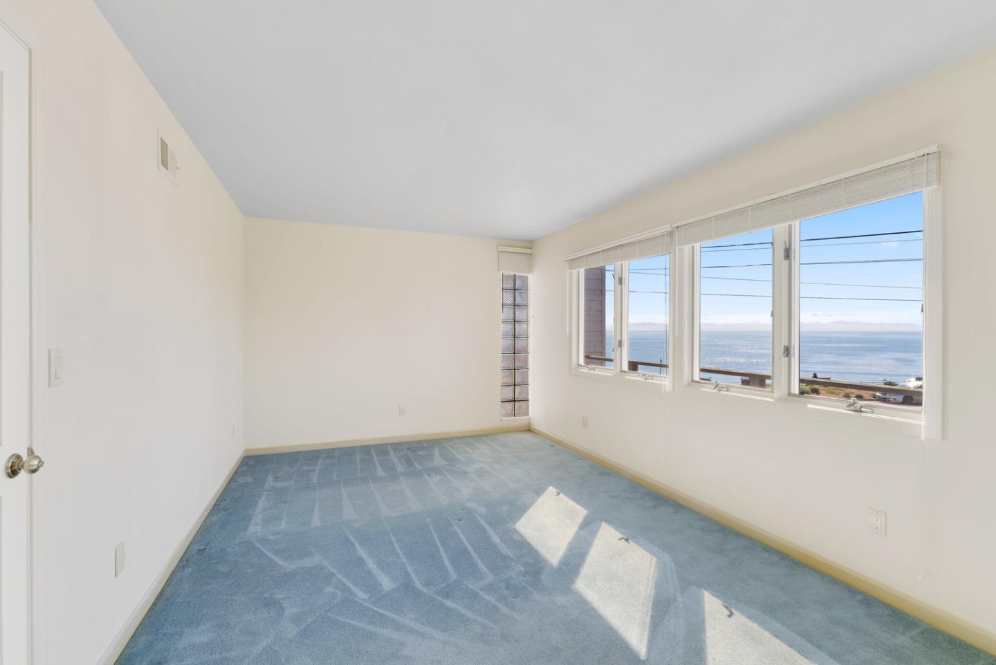 1385 Prospect Avenue Capitola, CA 95010 - Photo 30 of 41 an empty room with wooden floor and windows