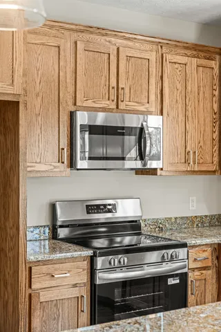 a kitchen with stainless steel appliances granite countertop a stove a sink and a granite counter space