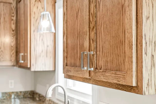a close view of a kitchen counter top a stove and a window