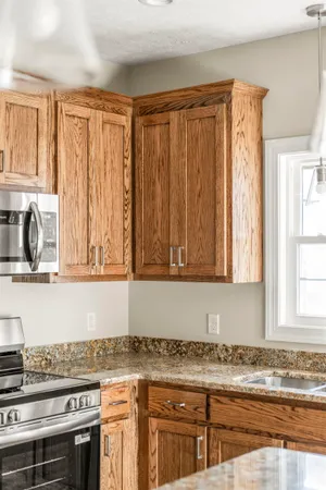 a kitchen with stainless steel appliances granite countertop a stove a sink and a granite counter space