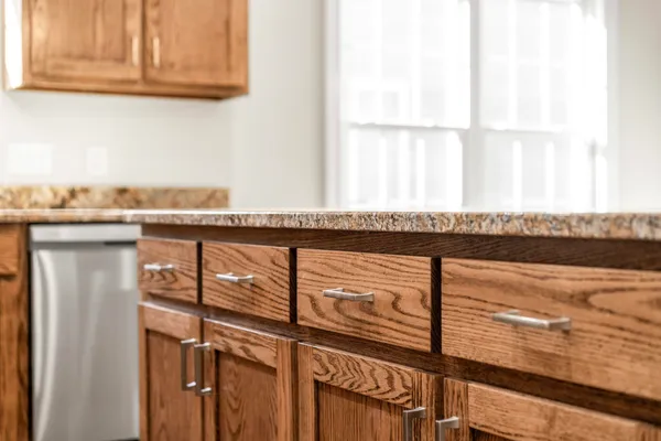 a close view of a kitchen counter top a stove and a window