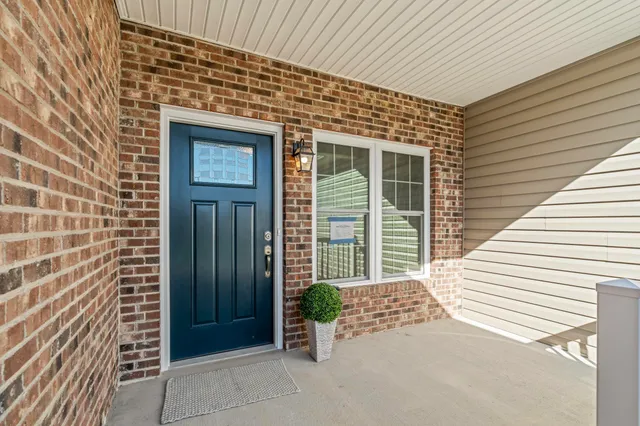 a view of a brick house with a door and wooden floor
