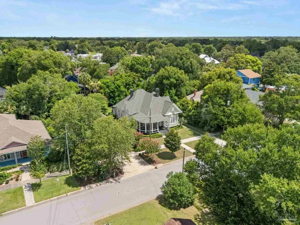 an aerial view of a house with a yard