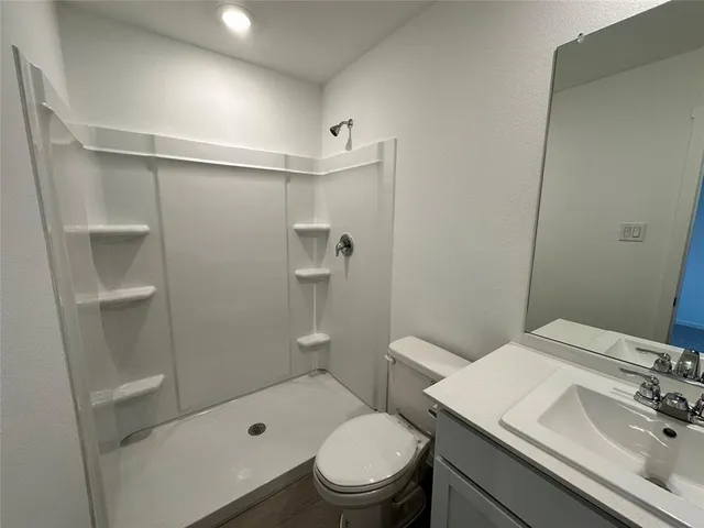 a bathroom with a sink toilet and shower