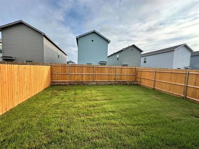 a view of a backyard with hardwood area