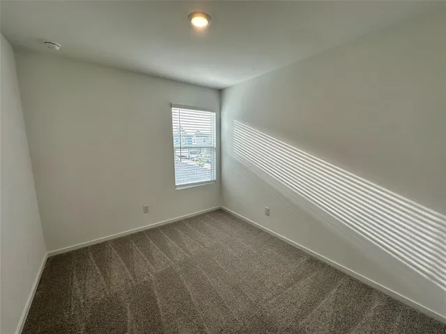 a view of an empty room and a window