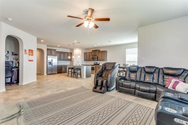 a living room with furniture and kitchen view