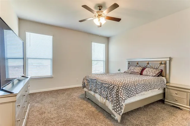 a bed sitting in a bedroom next to a window