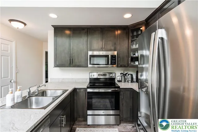 a kitchen with a sink and stainless steel appliances
