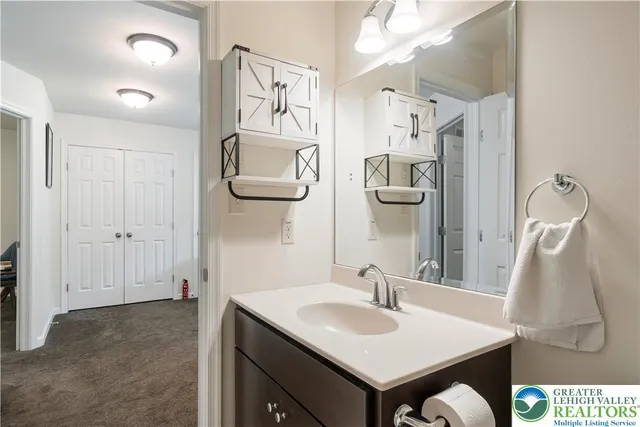 a en suite bathroom with a sink and mirror