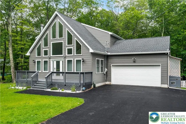 a front view of a house with a garden and yard