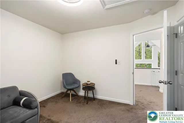 a view of a bedroom with baby crib and cabinet