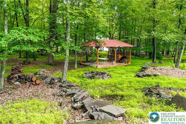 a view of a patio with a table chairs and a backyard