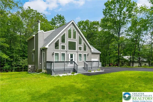 a front view of house with yard and green space