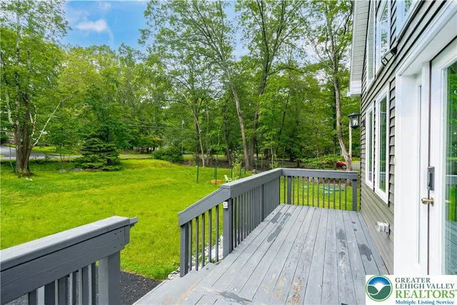 a view of deck with chairs and a yard