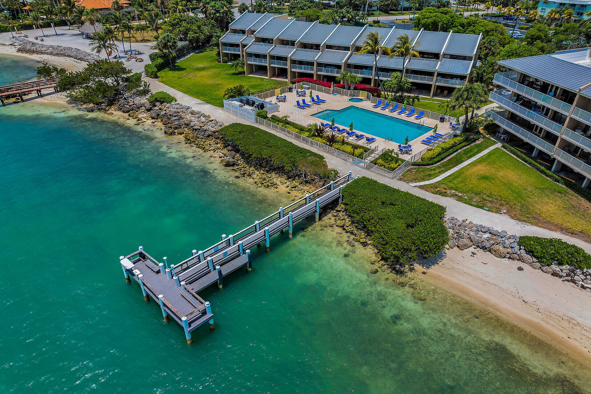 1133 West Ocean Drive, Unit 6 Key Colony Beach, FL 33051 - Photo 19 of 73 an aerial view of a chairs and table on the field