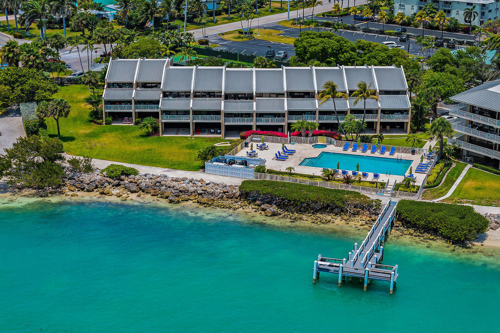 1133 West Ocean Drive, Unit 6 Key Colony Beach, FL 33051 - Photo 21 of 73 an aerial view of a swimming pool with lawn chairs and plants